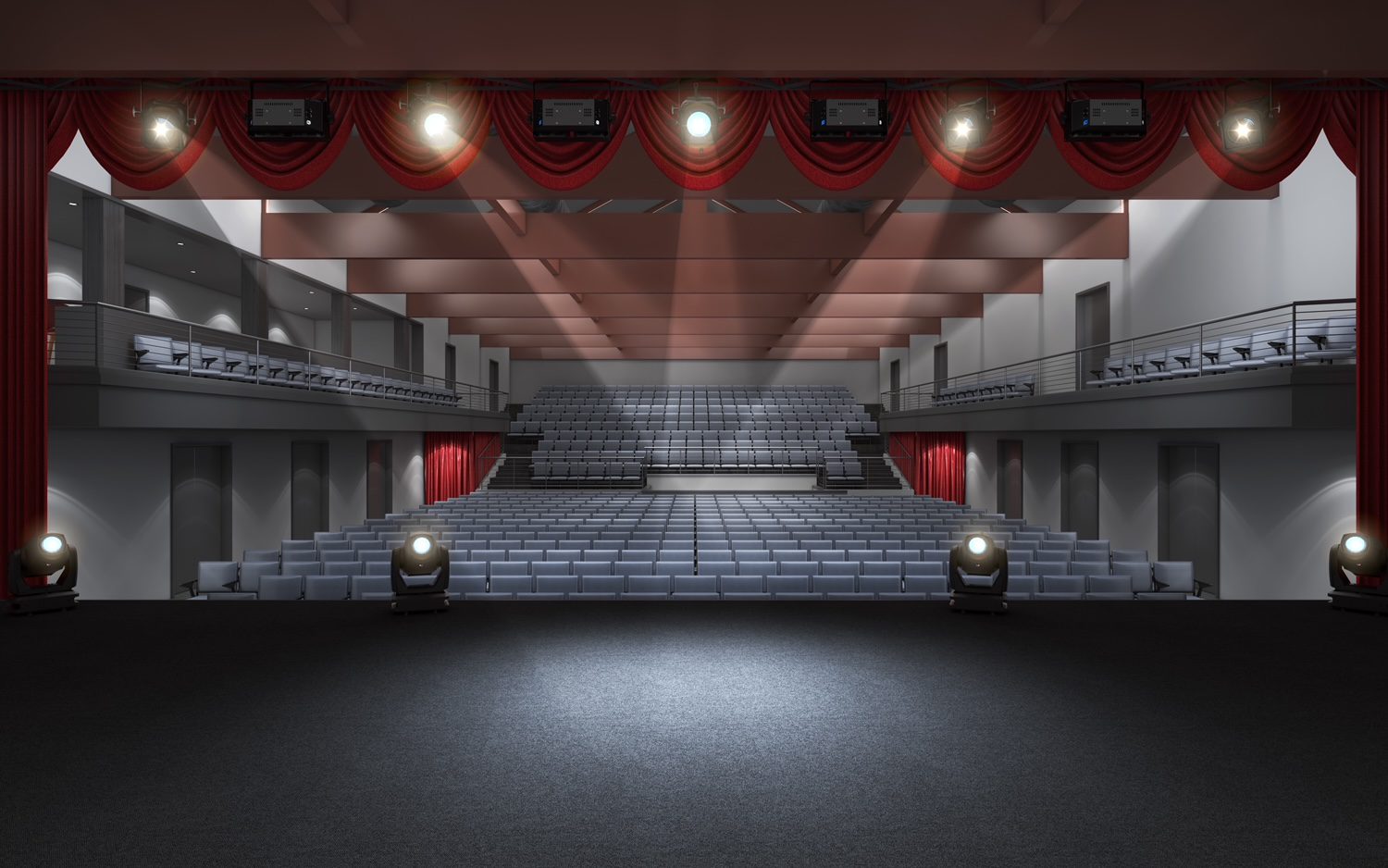 A large empty stage with lights on the ceiling.