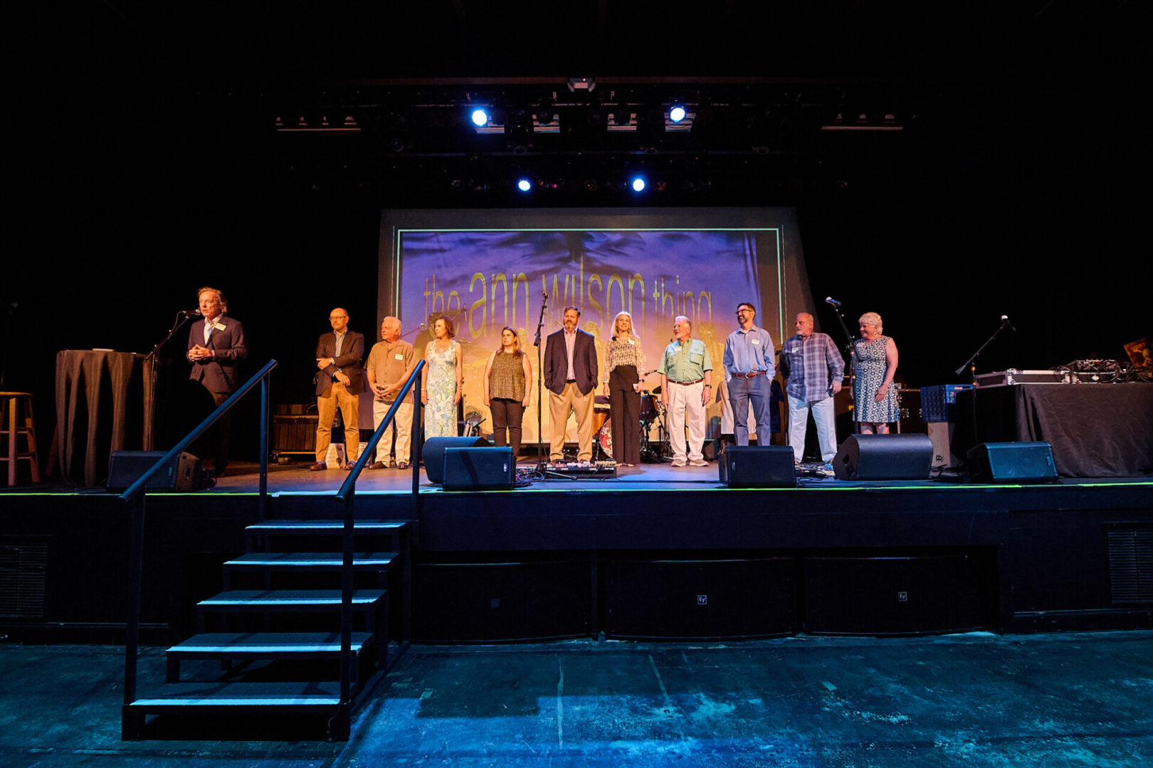 A group of people standing on top of a stage.